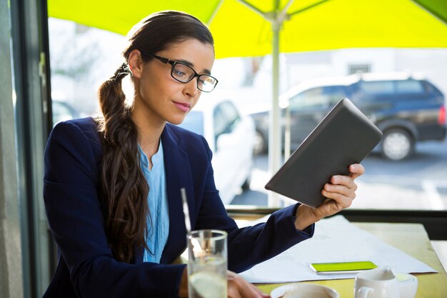 Zakenman met behulp van digitale tablet in café