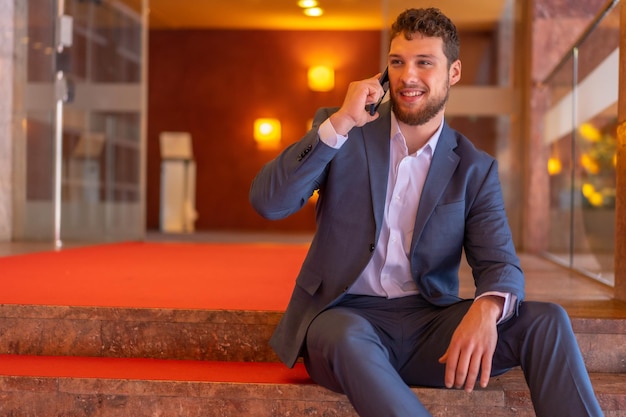 Zakenman of financiële man zit op de trappen van de kantoren waar hij de CEO van het bedrijf is