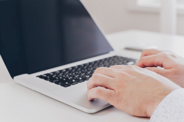 Zakenman op het werk. Close-up bovenaanzicht van de man die op laptop werkt