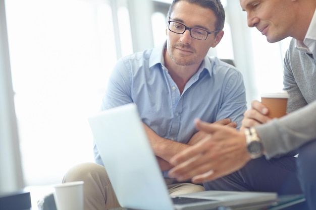 Zakenmanlaptop en ideestrategie in discussie voor dealvoorstel of bedrijfsidee op kantoor Mensen uit het bedrijfsleven die ideeën delen voor marktplanning of reclame in gesprek op de werkplek