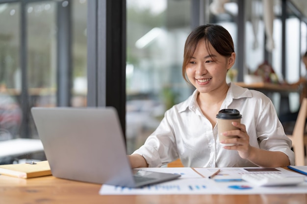 Zakenvrouw typen op laptop rapport analyseren van werkresultaten vrouwelijke executive doet papierwerk op de werkplek met behulp van online computersoftware voor gegevensanalyse