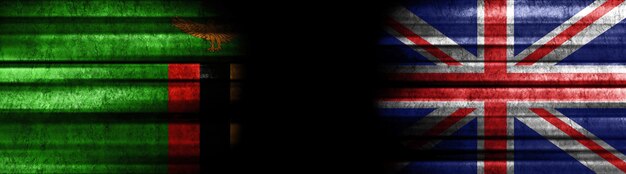 Photo zambia and united kingdom flags on black background