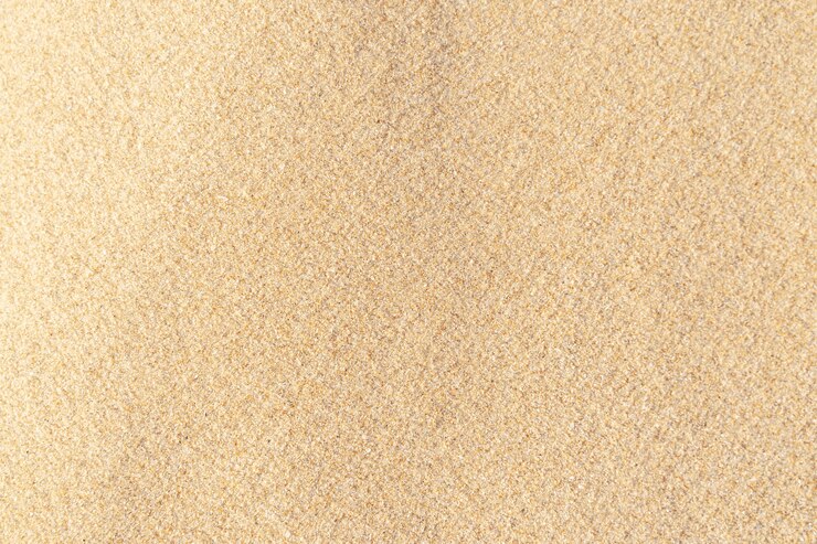 Foto zand textuur achtergrond. bruin woestijnpatroon van tropisch strand. detailopname.
