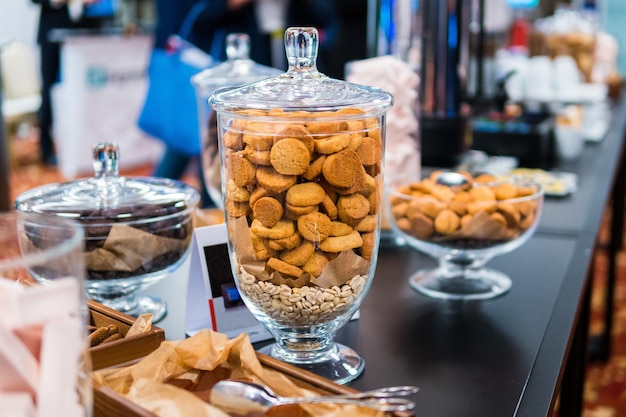 Zandkoekkoekjes in glaswerk en andere zoetigheden op de buffettafel tijdens de koffiepauze