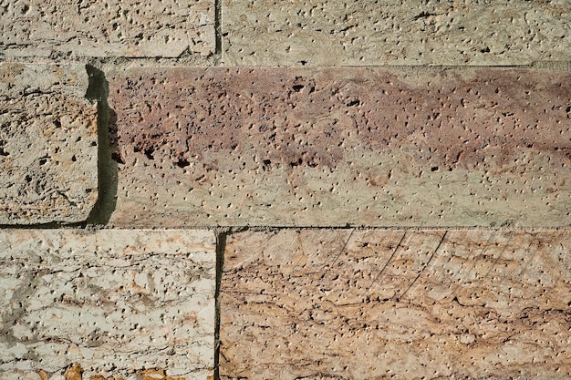 Zandstenen muur achtergrond of textuur voor behang Metselwerk muur voor de gevel van een huis of gebouw ontwerp en binnenruimte