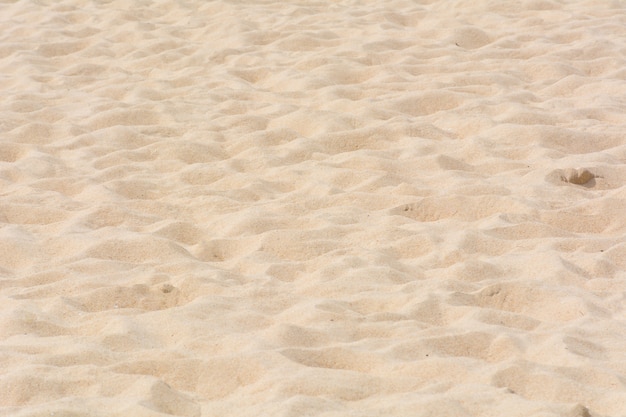 Zandtextuur op het strand als achtergrond