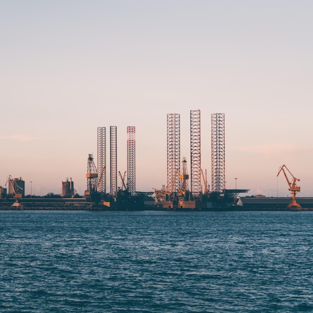 Zee bij de haven tegen een heldere hemel bij zonsondergang