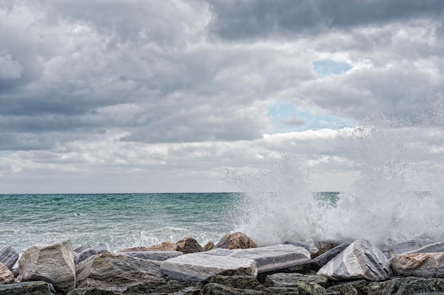 Zee in storm op rotsen