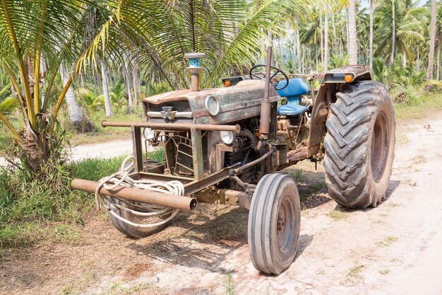 Zeer oude tractor op een onverharde weg in de jungle van Thailand