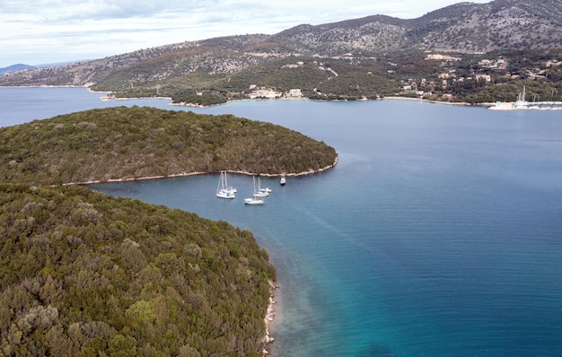 Zeilboten verankerd in een kleine baai in de luchtfoto van de Ionische kust van Epirus Zeilen in Griekenland in de buurt van Sivota