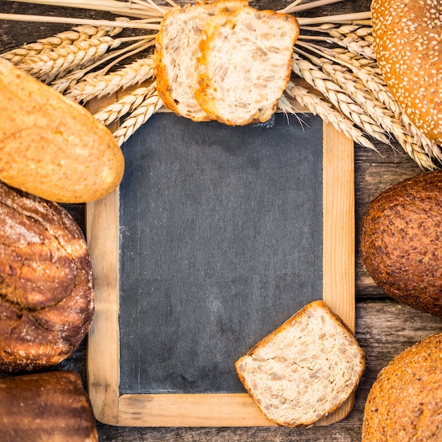 Zelfgebakken brood en tarwe op de houten tafel in herfst veld