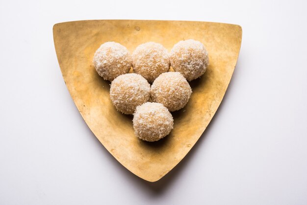 Zelfgemaakte Coconut Sweet Laddoo OF Nariyal Laddu gemaakt met gecondenseerde melk en suiker, populair festivalvoedsel. Geserveerd op een humeurige achtergrond, selectieve focus