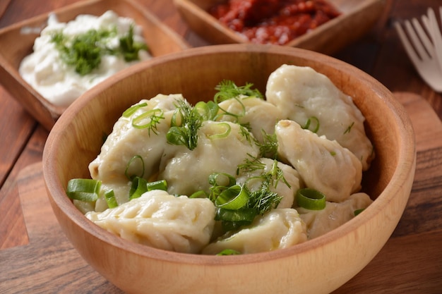 Zelfgemaakte dumplings Dagestan keuken Kurze Dumplings kurze met meet vulling en adjika hete saus op een bord