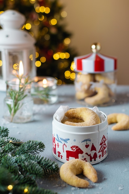 Zelfgemaakte kerst bakkerij, vanille halve maan koekjes met kaarsen, kerstboom en bokeh