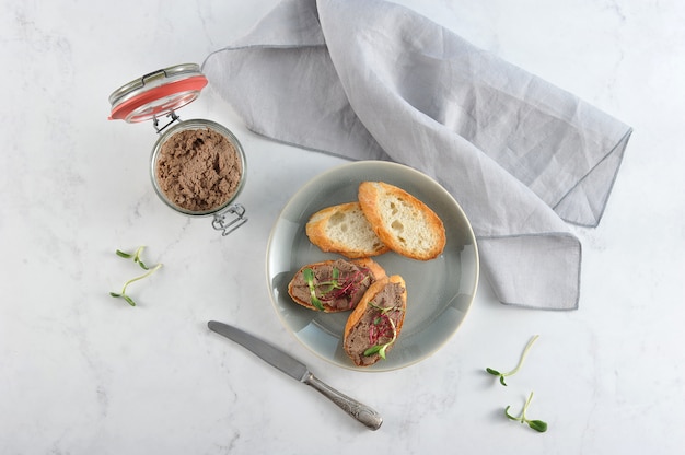 Zelfgemaakte paté in glazen pot en geroosterde toast