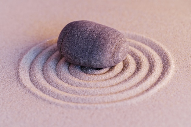 Zen garden stones on sand with ornament copy space