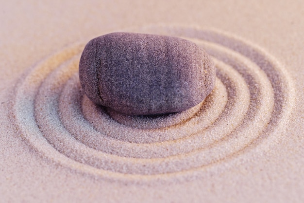 Zen garden stones on sand with ornament copy space