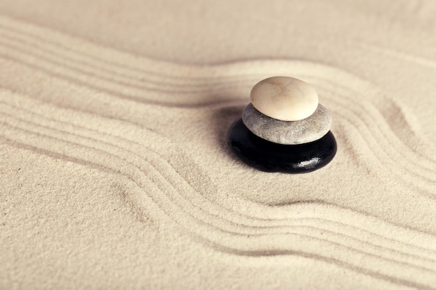 Zen garden with stones on sand background