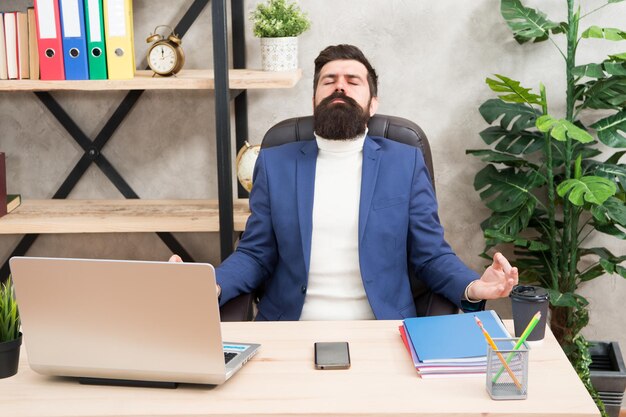 Zen like. Businessman meditate in formal outfit. Confident man relax on mediation. Boss meditate at workplace. Bearded man meditate in business office. keeping calm inside his soul.