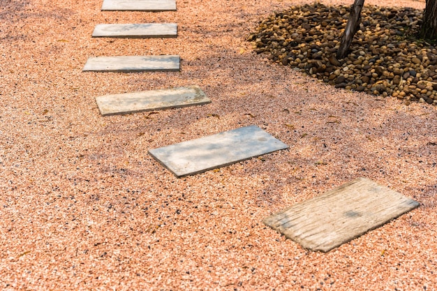 Zen stone path on gravel floor in the garden