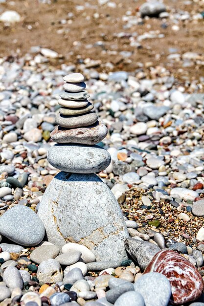 Zen stones stacked at beach against a sand and gravel background