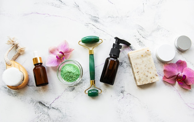 Zero waste bathroom accessories and jade roller on a marble\
surface