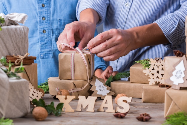 Zero waste christmas concept father and son wrapping gifts