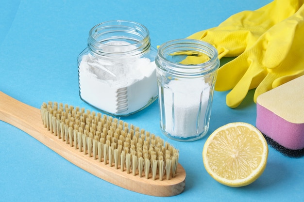 Zero waste cleaning concept Lemon wooden brush  loofah and soda on a blue background