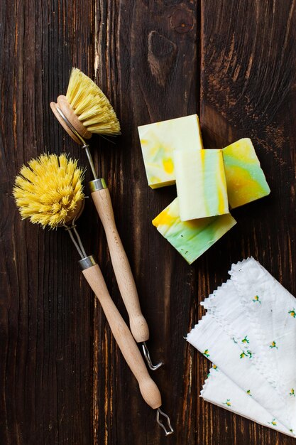 Zero waste, compostable cleaning tools. Wooden dish brush, organic homemade soap. Eco friendly concept for kitchen