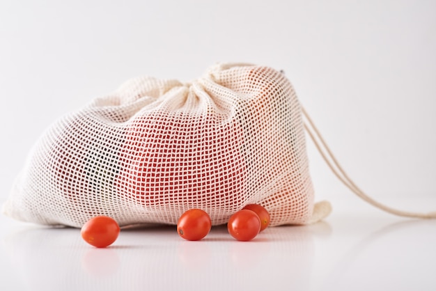 Zero waste concept. Fresh organic vegetables in textile bag on a white background. 