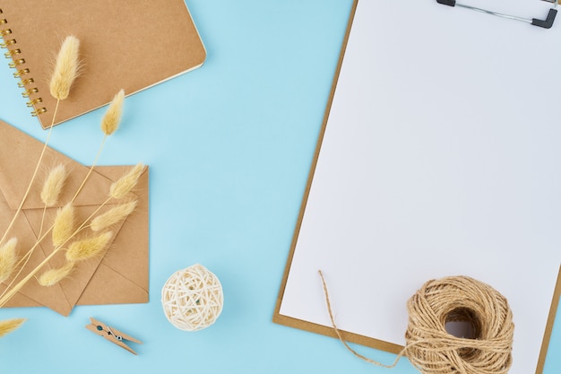 Zero waste concept. White sheet on clipboard, craft envelopes