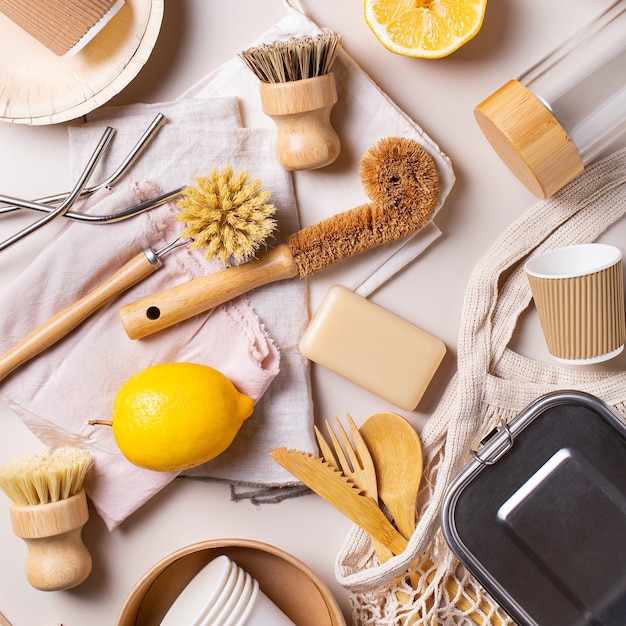 Zero waste eco friendly, sustainable consumption concept. High angle view of plastic free kitchen cleaning tools, cotton bags, reusable cutlery and utensils made from recycled materials