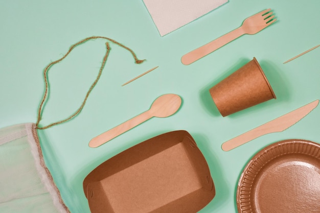 Zero waste environmentally friendly disposable cardboard paper utensils on a blue background