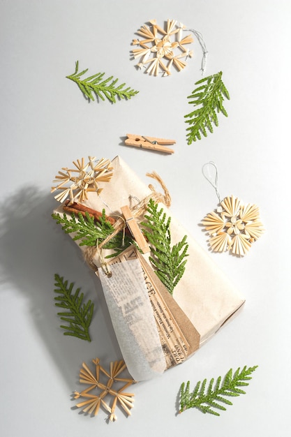 Zero waste gift concept. Christmas or New Year eco-friendly packaging. Festive boxes in craft paper with different organic decorations. Trendy hard light, dark shadow, flat lay, top view