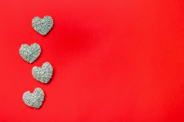 Zero waste, Valentine's Day eco-friendly concept. Hearts with yarn on red background.