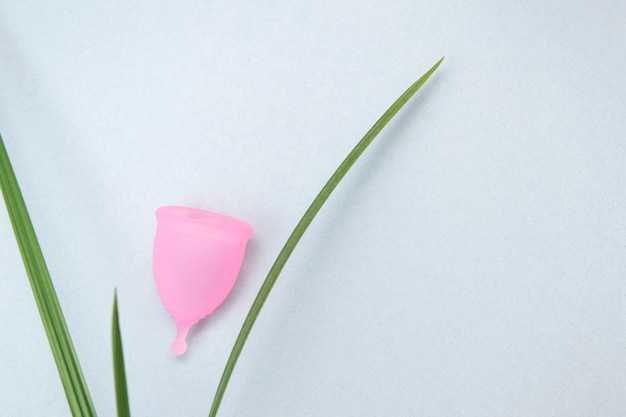 Photo zero waste.women health concept. eco-friendly. pink menstrual cup on a gray