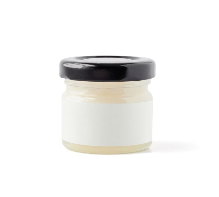 Foto zijaanzicht van gesloten pot met cosmetische olie of huidverzorgingscrème geïsoleerd op een witte achtergrond