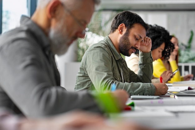 Foto zijaanzicht volwassenen die samen studeren