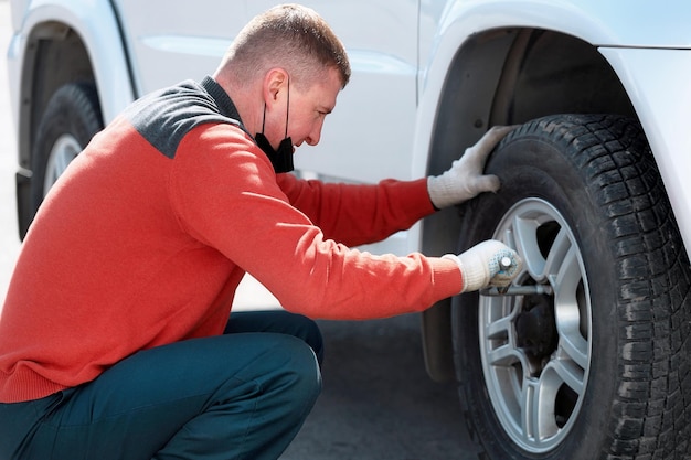 Foto zijkant van een man die een auto vasthoudt