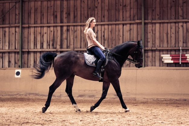Zijkant van een vrouw op een paard