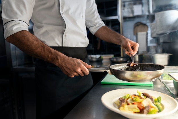 Zijkant zicht professionele chef-kok aan het werken