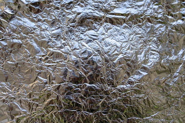 Foto zilverkleurige verfrommelde aluminiumfolie achtergrond