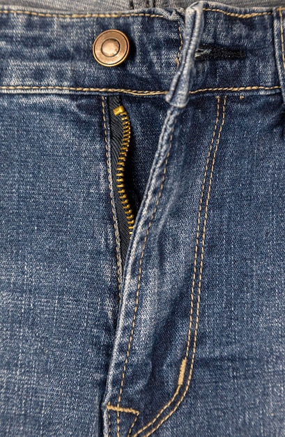 Zipper with lock on denim texture closeup of fastener on blue jeans metal zipper