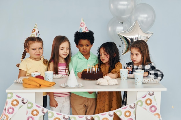 Zit bij de tafel Kinderen op verjaardagsfeestje binnenshuis hebben plezier samen