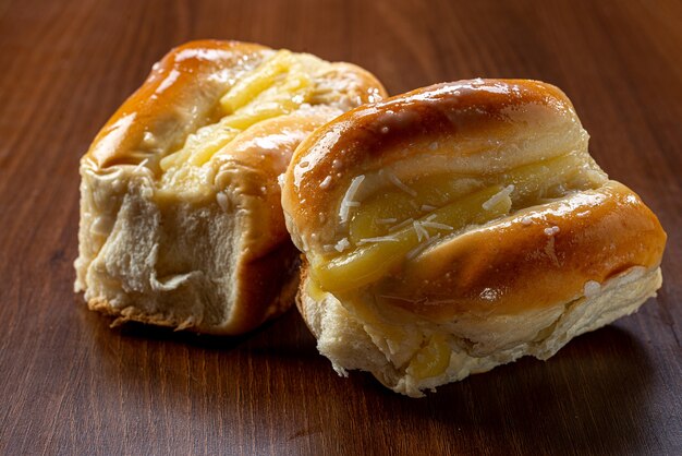 Zoet vanillecrème brood op een bruine houten tafel. Het is een soort brood dat veel voorkomt in Brazilië en Portugal, gemaakt met zoet deeg.