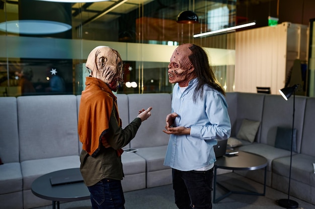 Photo zombie coworkers speaking together in office
