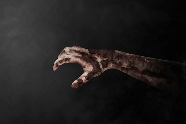 Photo zombie hand with blood and wound with black background