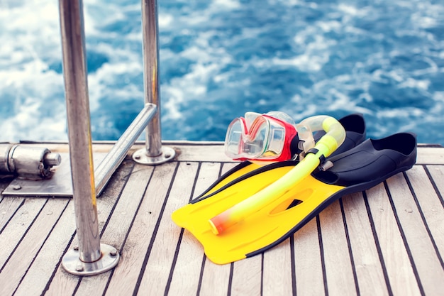 Zomer en vakantie concept. Zeezicht. Duikmasker en zwemvliezen op boot.