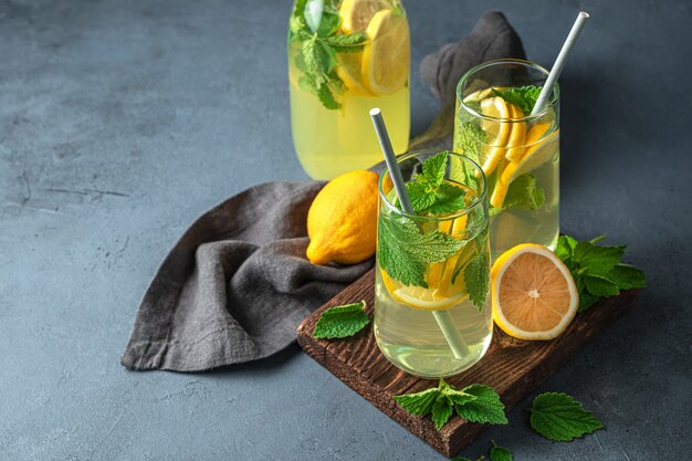 Zomer, gezond verfrissend drankje op een grafietachtergrond. Limonade met citroenen en munt. Ruimte kopiëren.