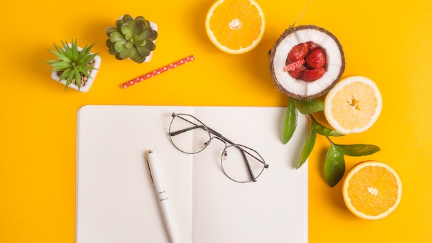 Zomer werkplek lay-out met Kladblok en fruit